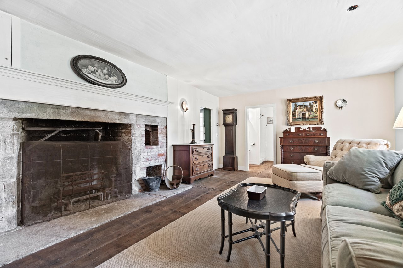 The formal living room with wide board floors, original stone fireplace and beehive oven illustrate how 1800 living can be easily accommodate modern day lifestyles.
