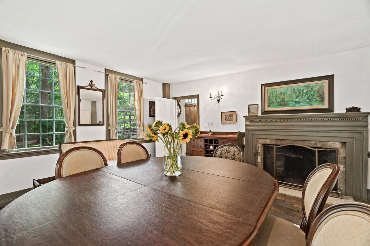 The dining room with its 12-over-12 windows and timeless fireplace is appreciated by guest arriving through the formal front entrance hall.