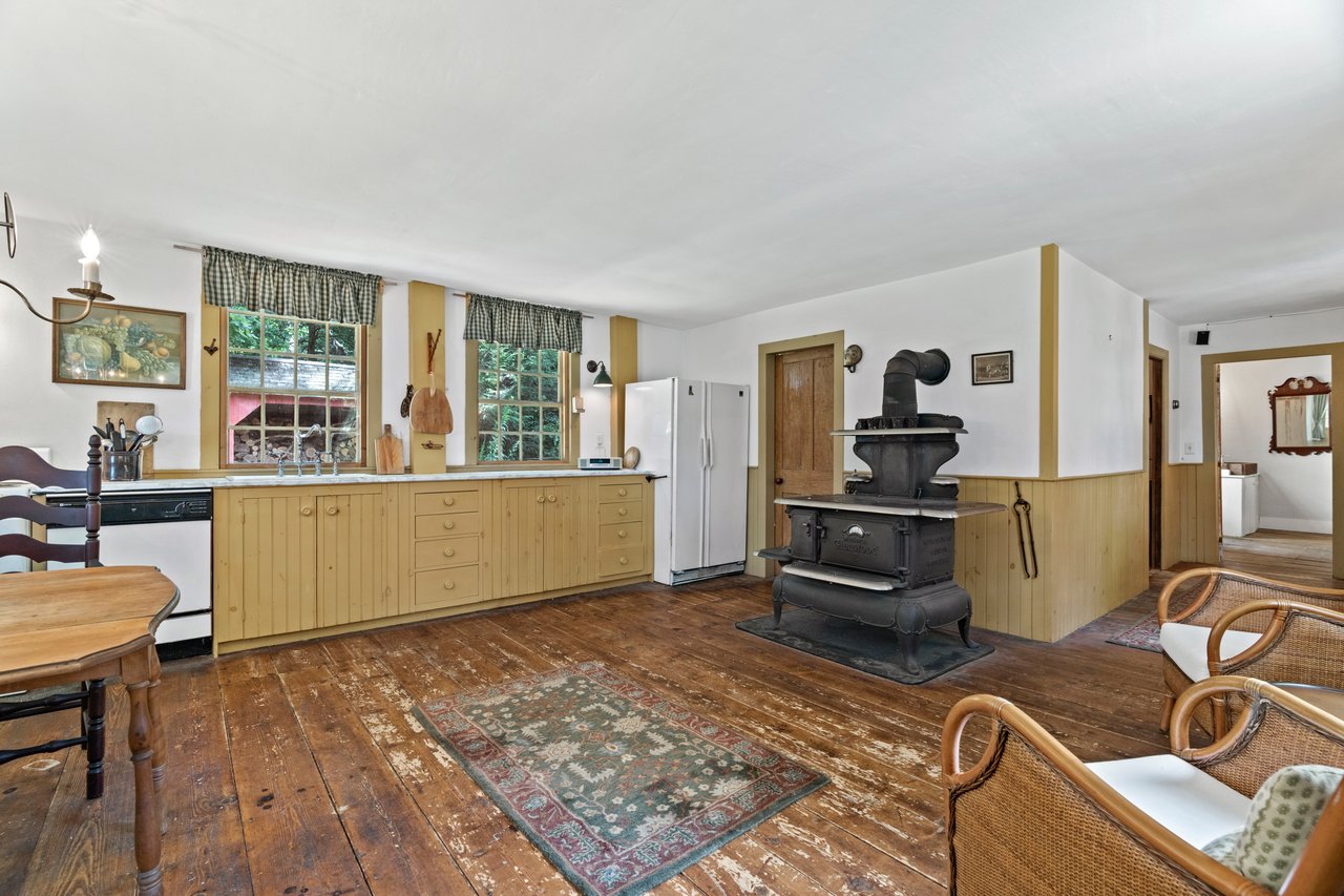 The kitchen has a vintage oven, a large pantry, and easy access to the side entrance and dinner service room.Enjoy the harmony of outdoor and indoor dining and entertaining with this easy access to the stone terrace.