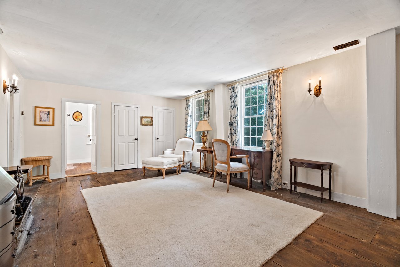 Currently a sitting area for the primary bedroom this area offers almost 250 square feet of flexible space with two access doors.
