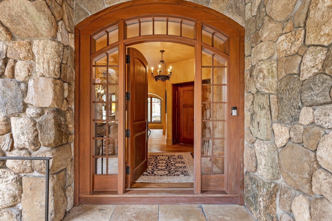 Exquisite entryway with custom hand crafted entrance door welcomes you