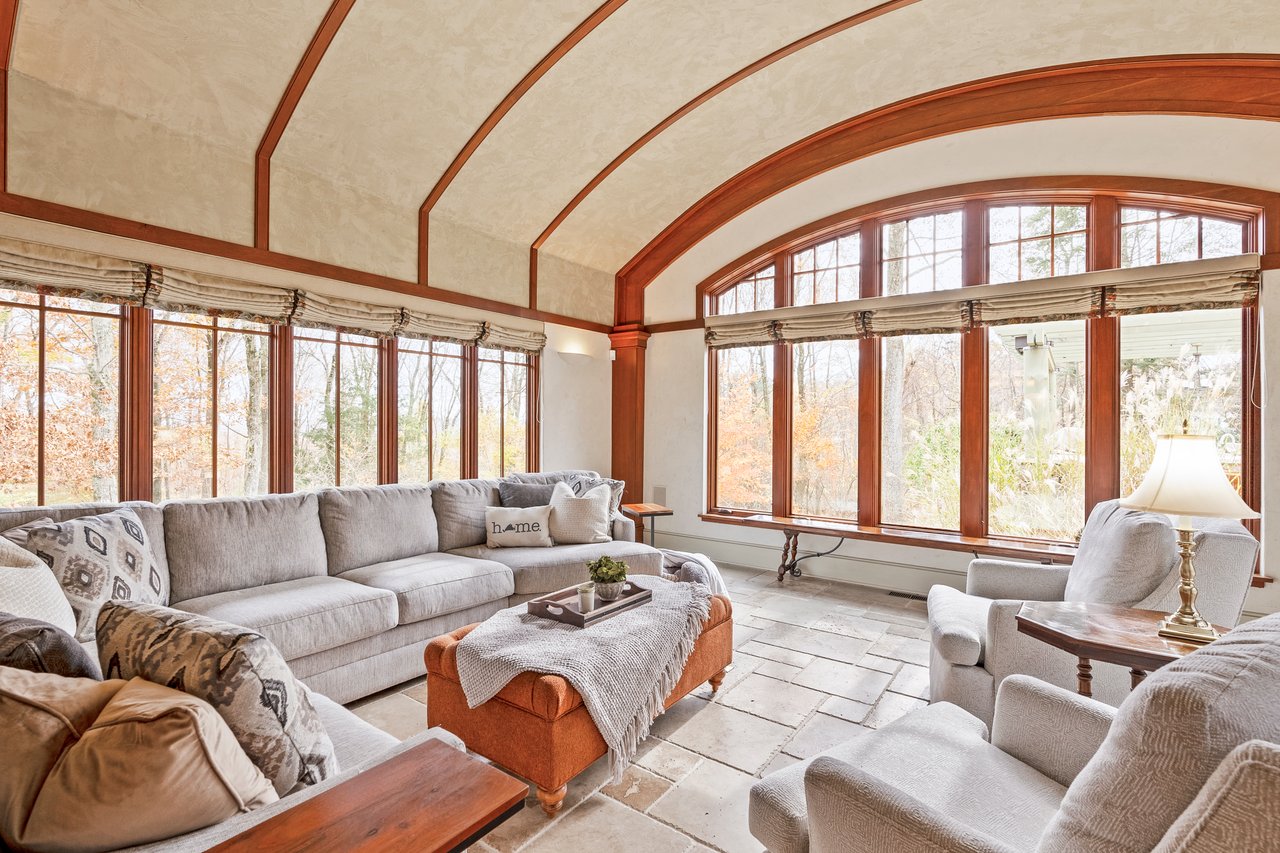 Casual family room with beautiful barrel ceiling crafted with wood trim offers a great place for relaxation
