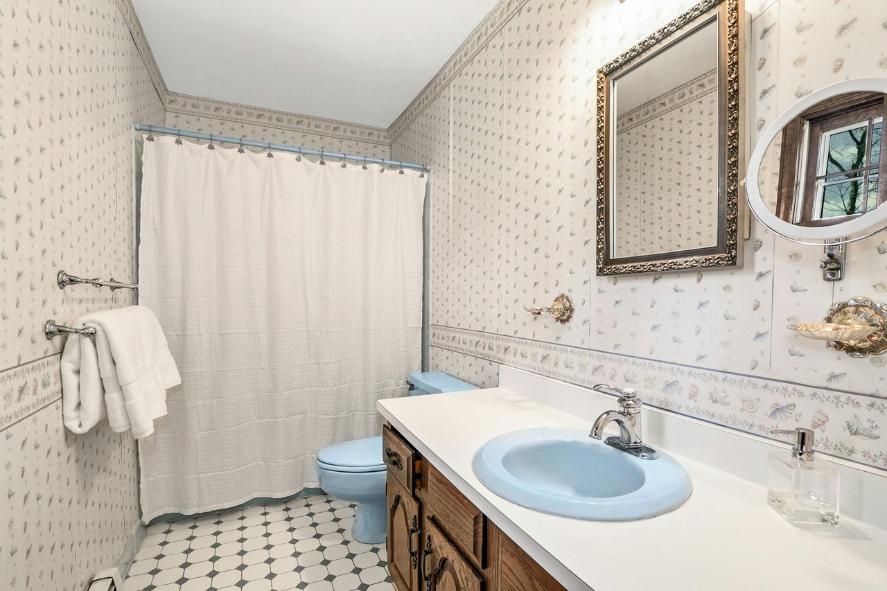 Primary bath - single sink vanity, tub-shower combination.