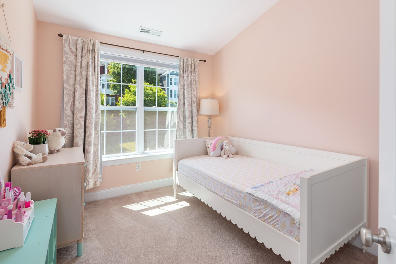 Sunny 2nd bedroom with large closet and vaulted ceiling.	