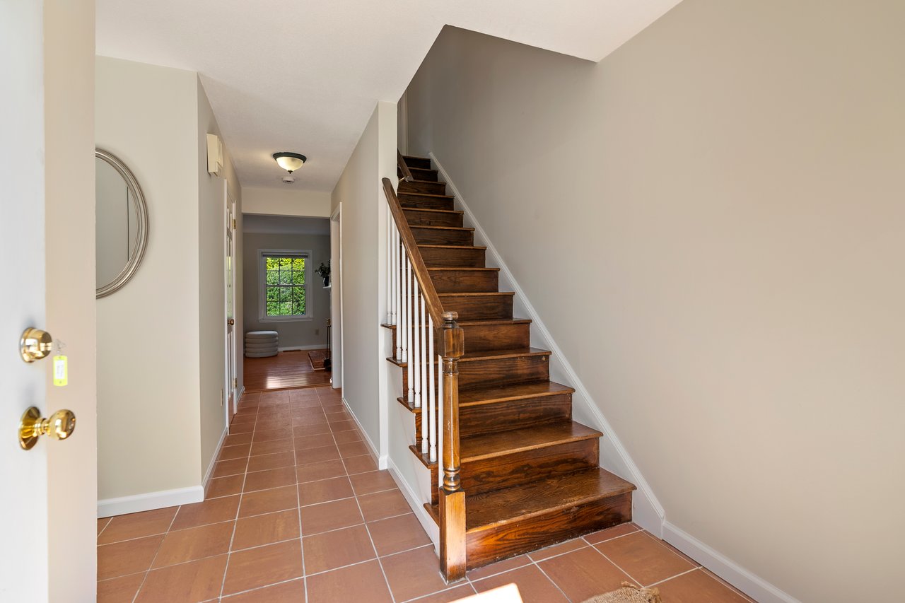 Welcoming foyer entrance with coat closet and tile floor