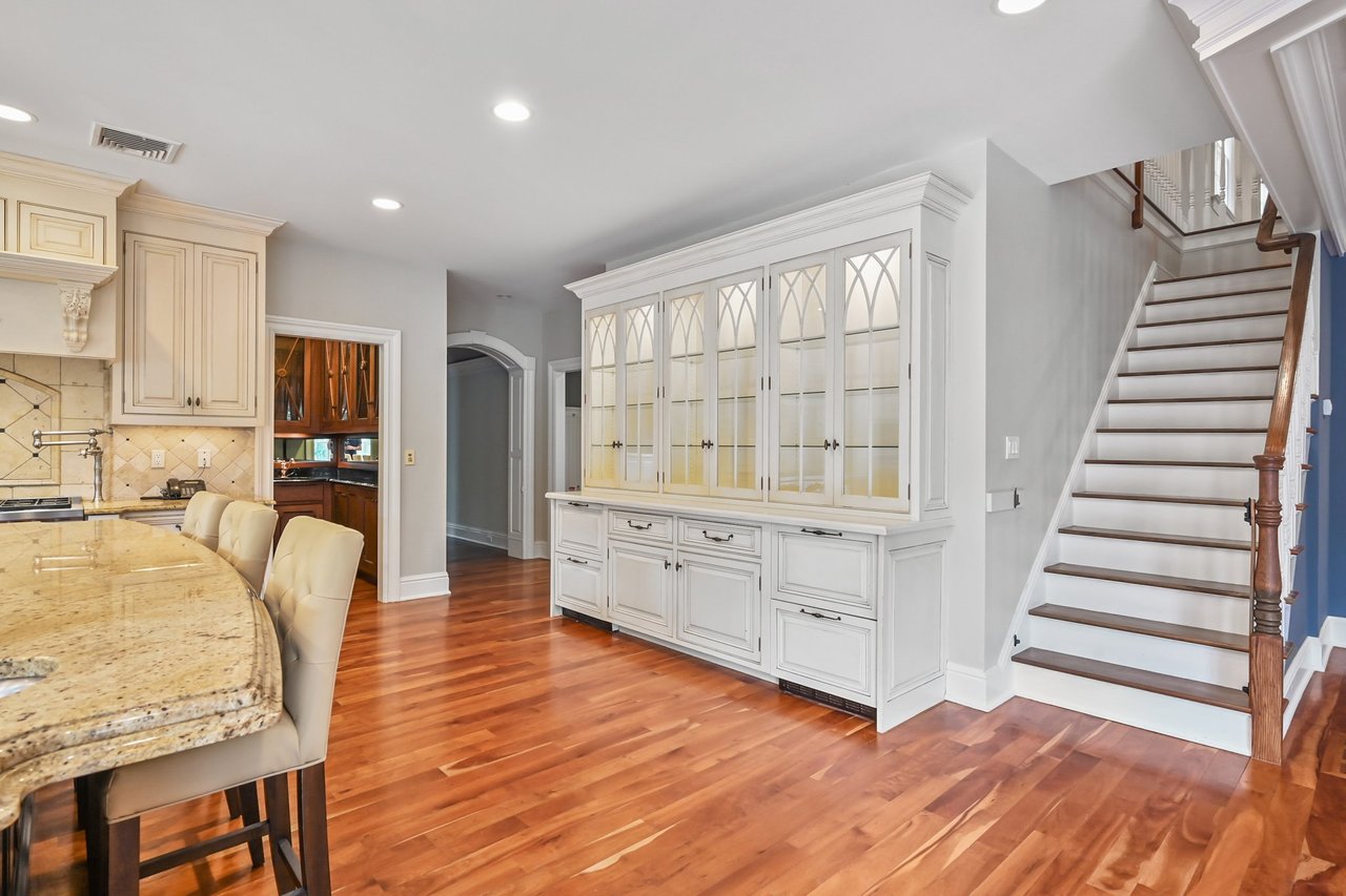 Beautiful China Cabinet graces one wall. Four beverage coolers housed in lower cabinets area.