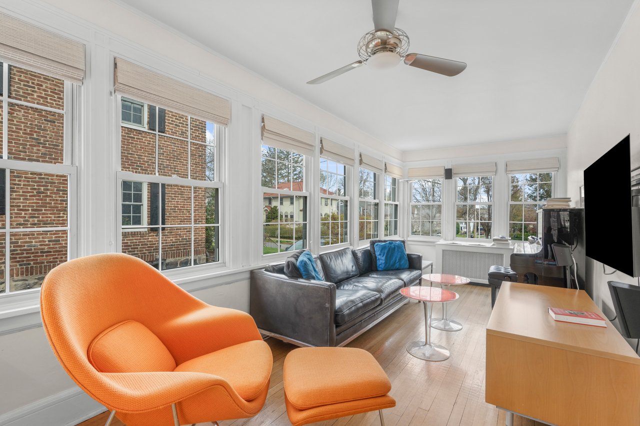 Sunroom / solarium with radiator heating unit and hardwood / wood-style flooring