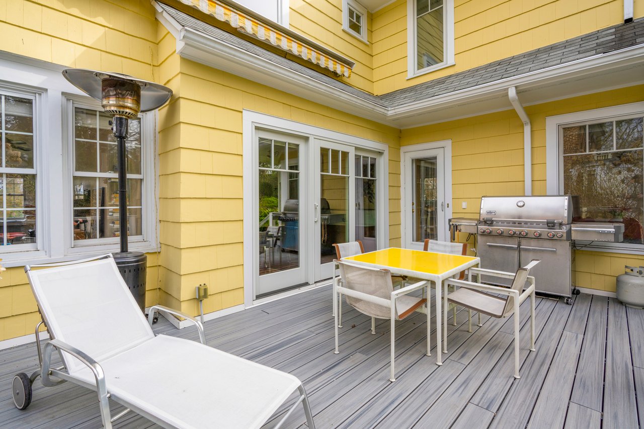 Wooden deck with outdoor dining space and a gril