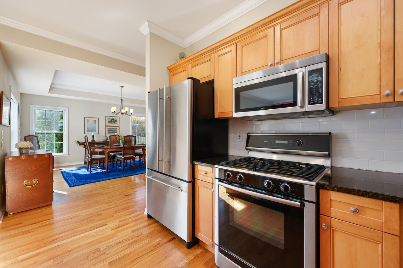 The Kitchen has pretty wood cabinetry and stainless steel appliances.
