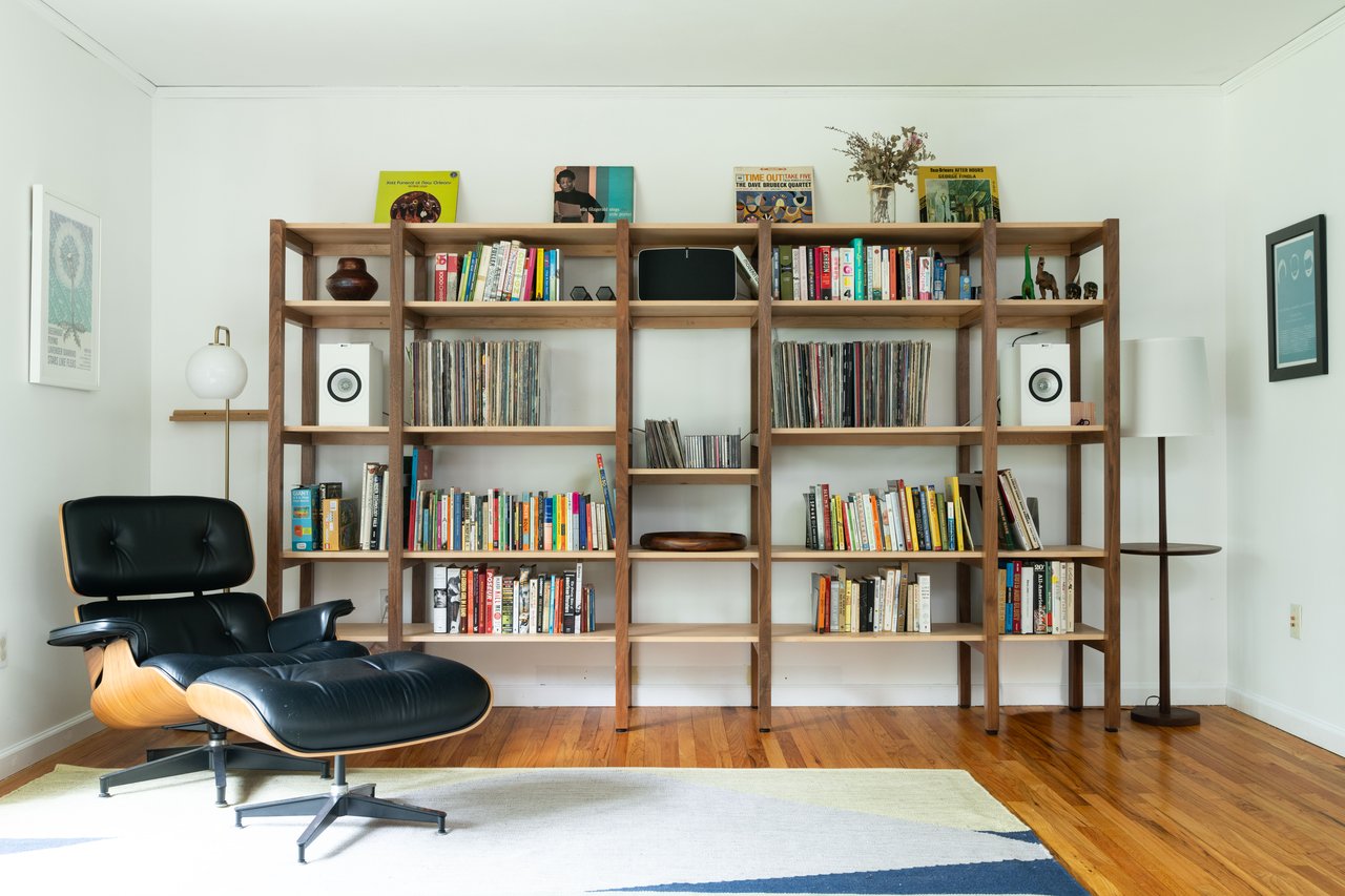 Sitting room with a baseboard radiator, wood finished floors, and baseboards...