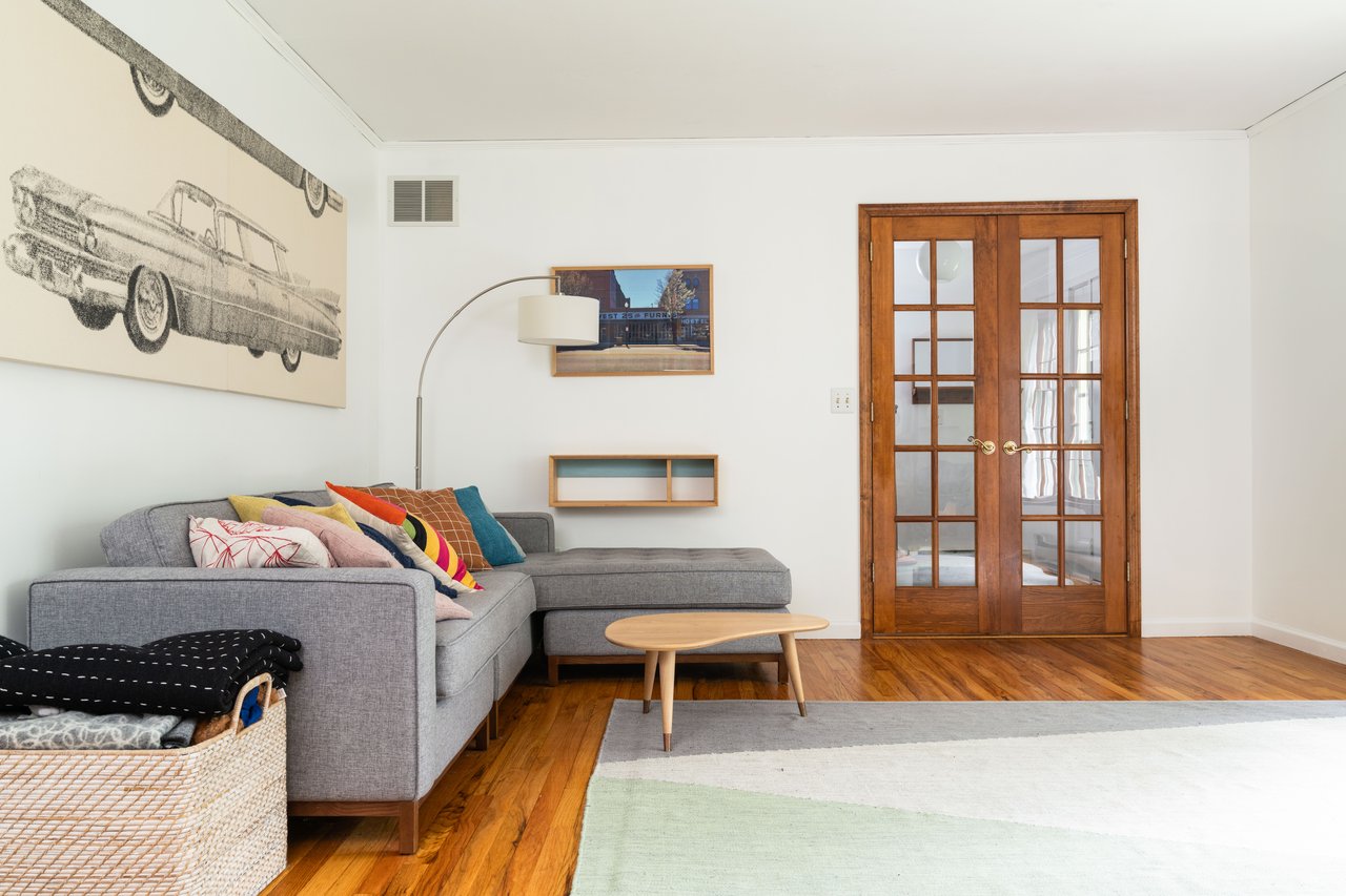 Living area featuring wood finished floors, french doors, and crown molding...