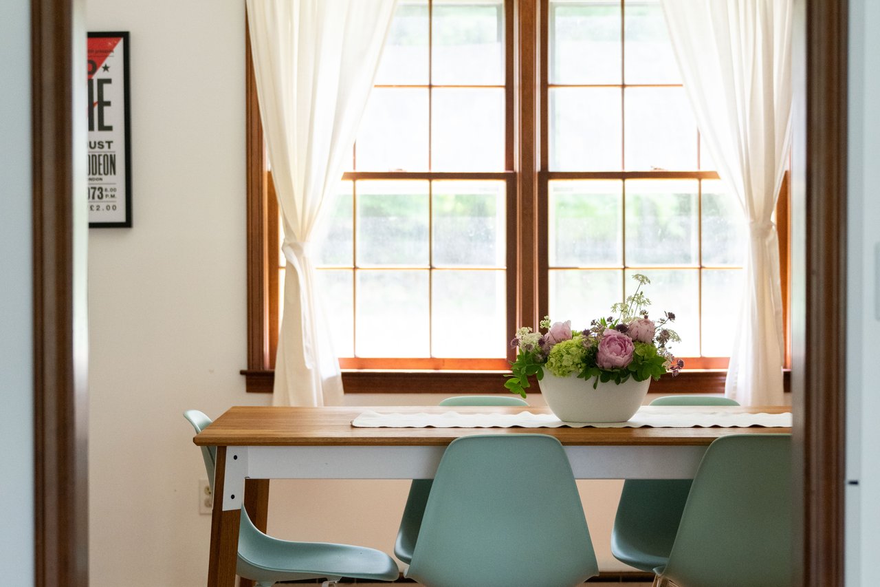 Dining area featuring a chandelier, baseboards, and wood finished floors...