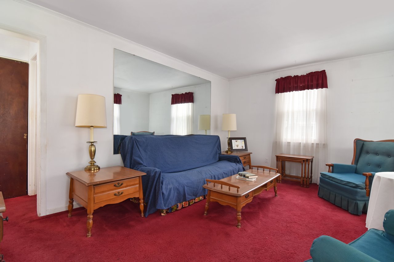 The living room connects to both the kitchen and two of the three bedrooms.
