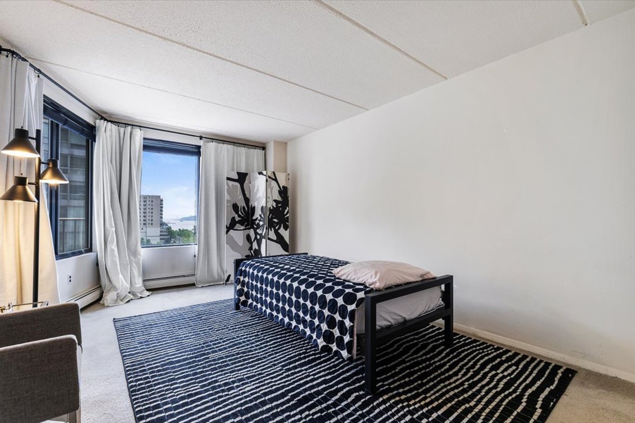 Bedroom featuring light colored carpet and baseboard heating