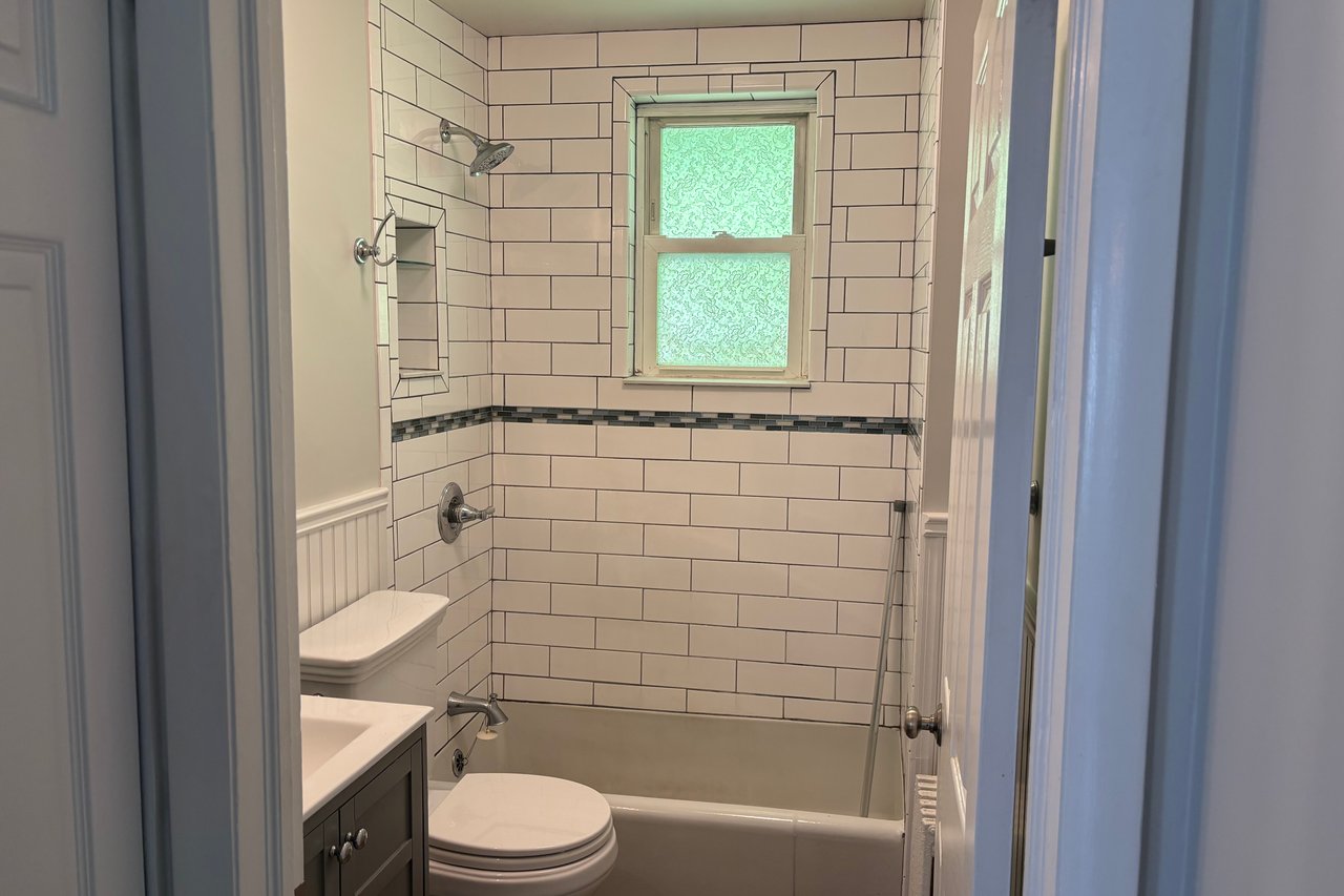 Bathroom featuring vanity and bathing tub / shower combination
