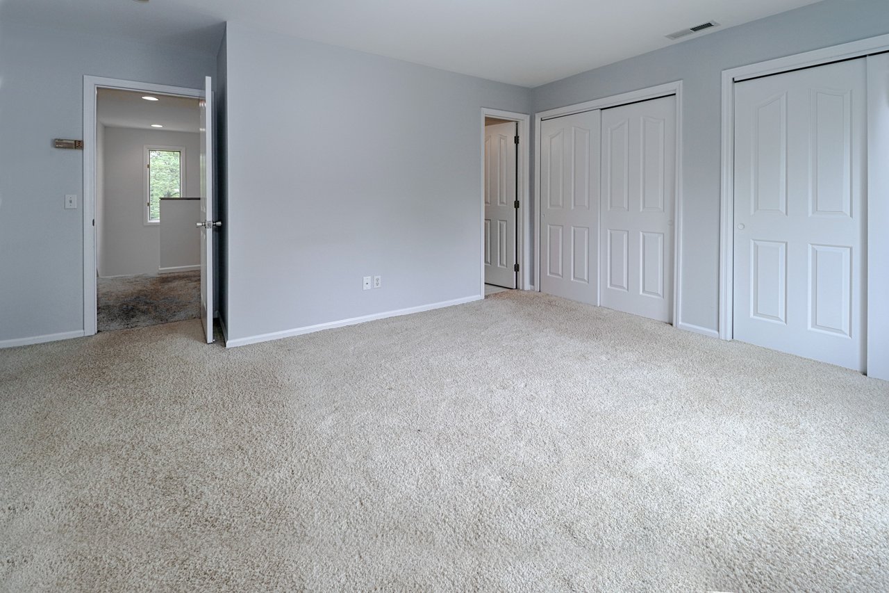 View of hallway and closets in primary bedroom.