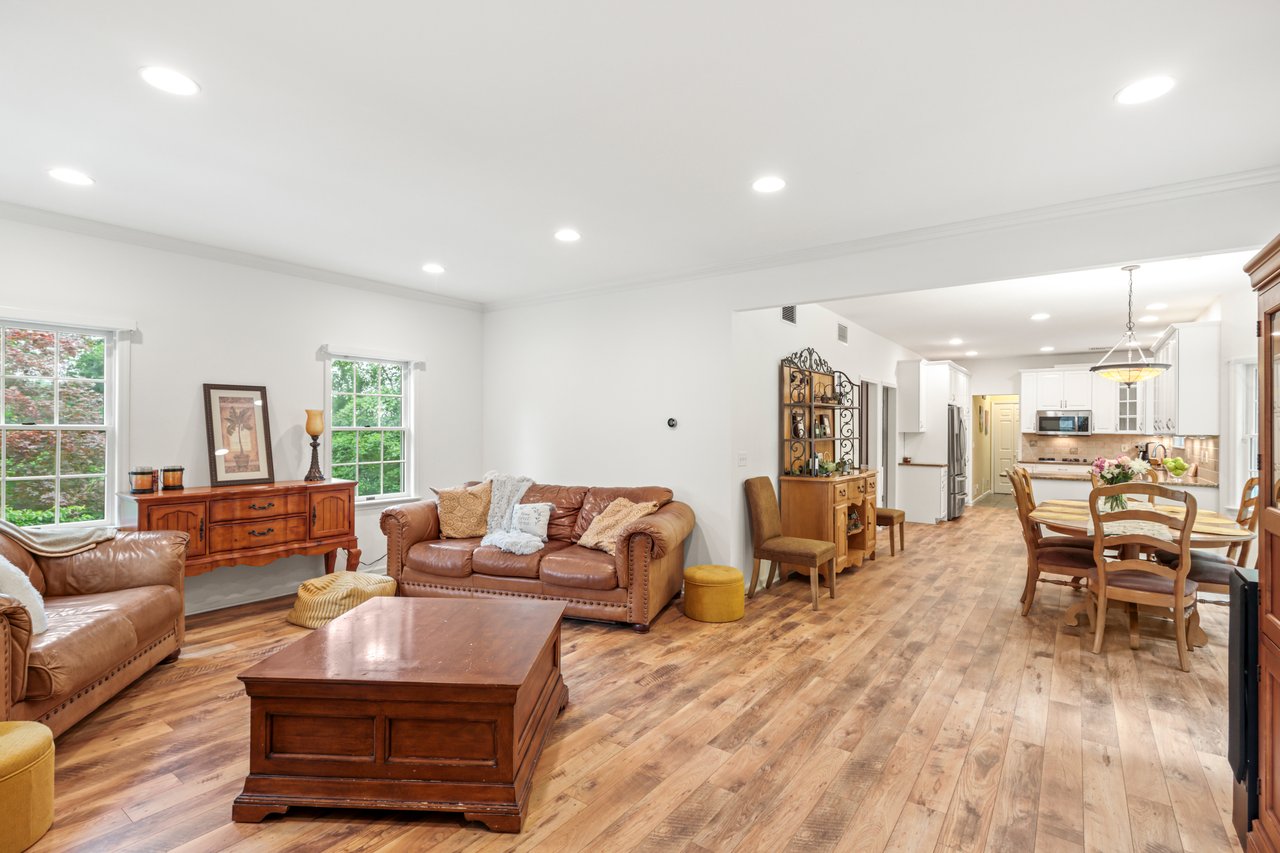 Living room featuring ornamental molding, light wood-style floors, and recessed lighting