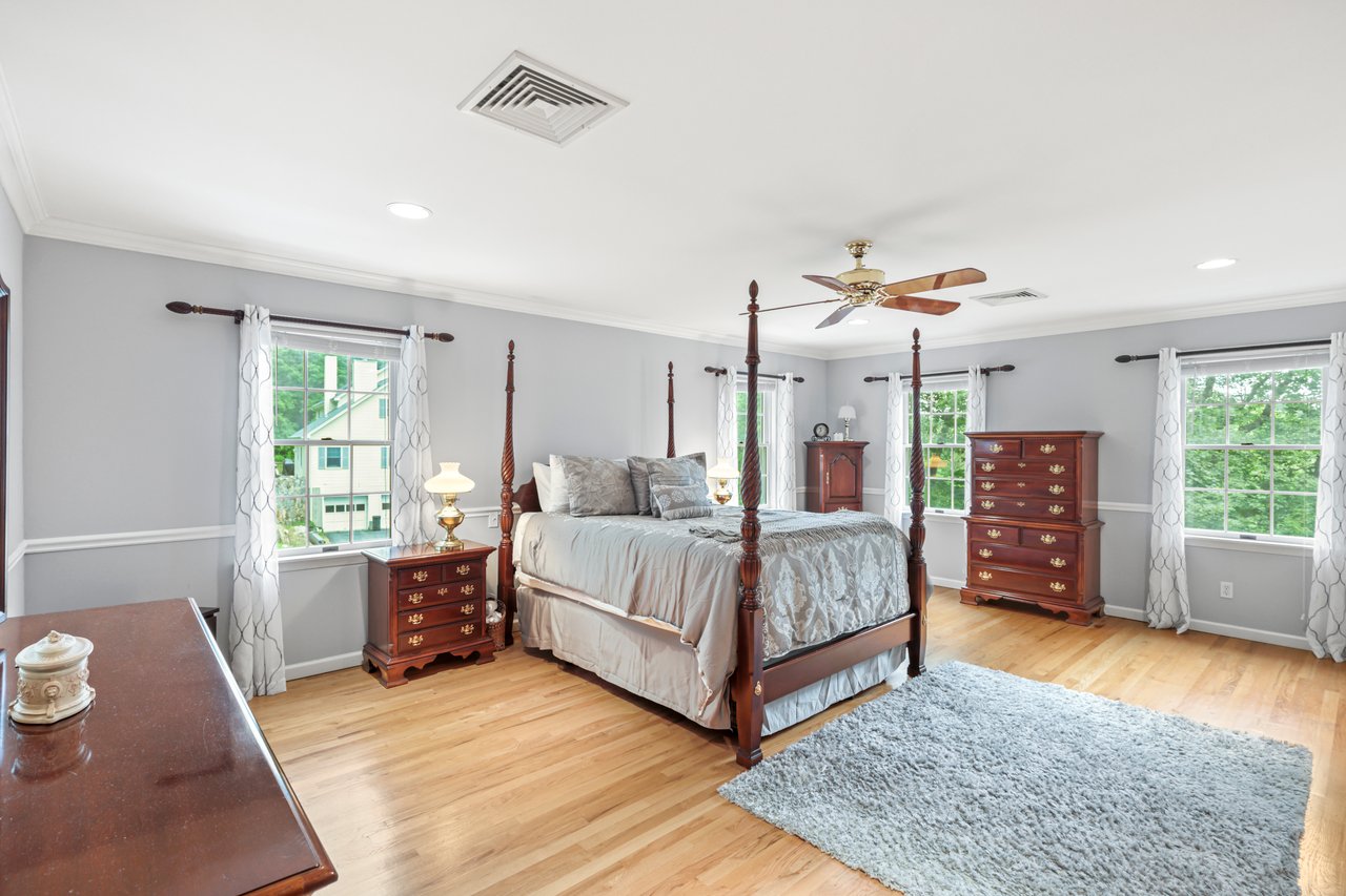 Bedroom with multiple windows, wood finished floors, crown molding, a ceiling fan, and recessed lighting
