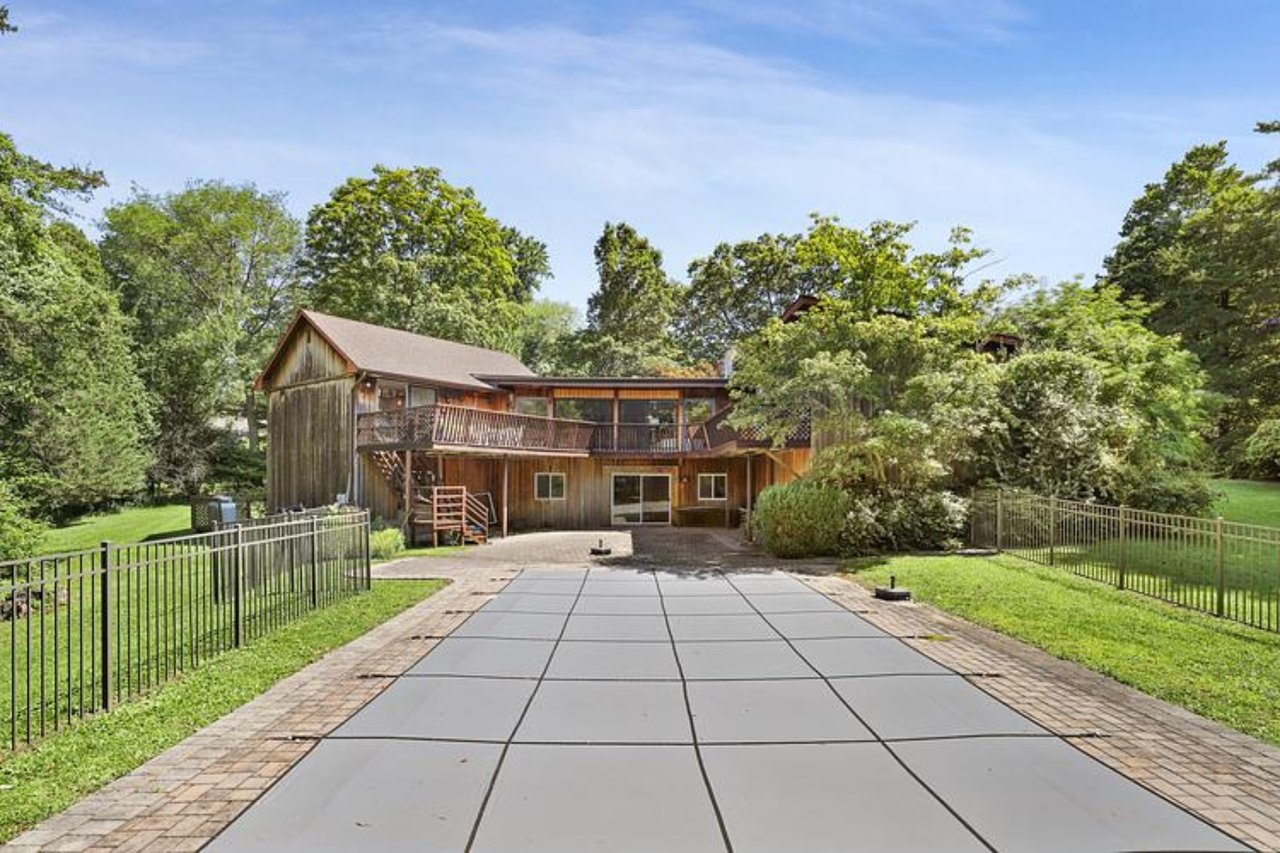 Back of property with a patio area, stairway, a fenced backyard, and a deck