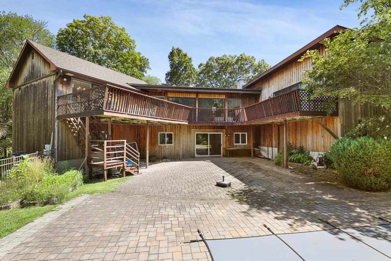 Back of property with a patio area, stairs, a deck, and decorative driveway
