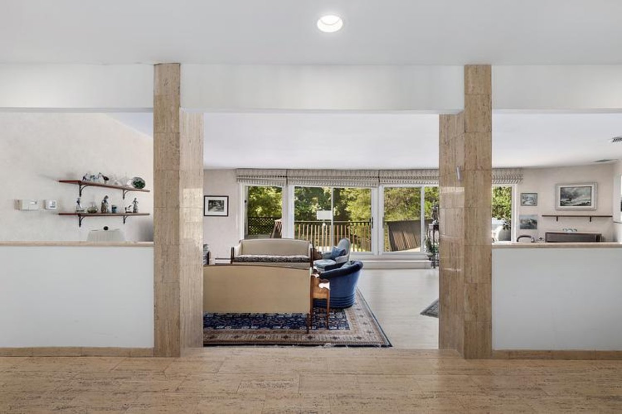 Step down to Living area featuring wood finished floors, healthy amount of natural light, and recessed lighting