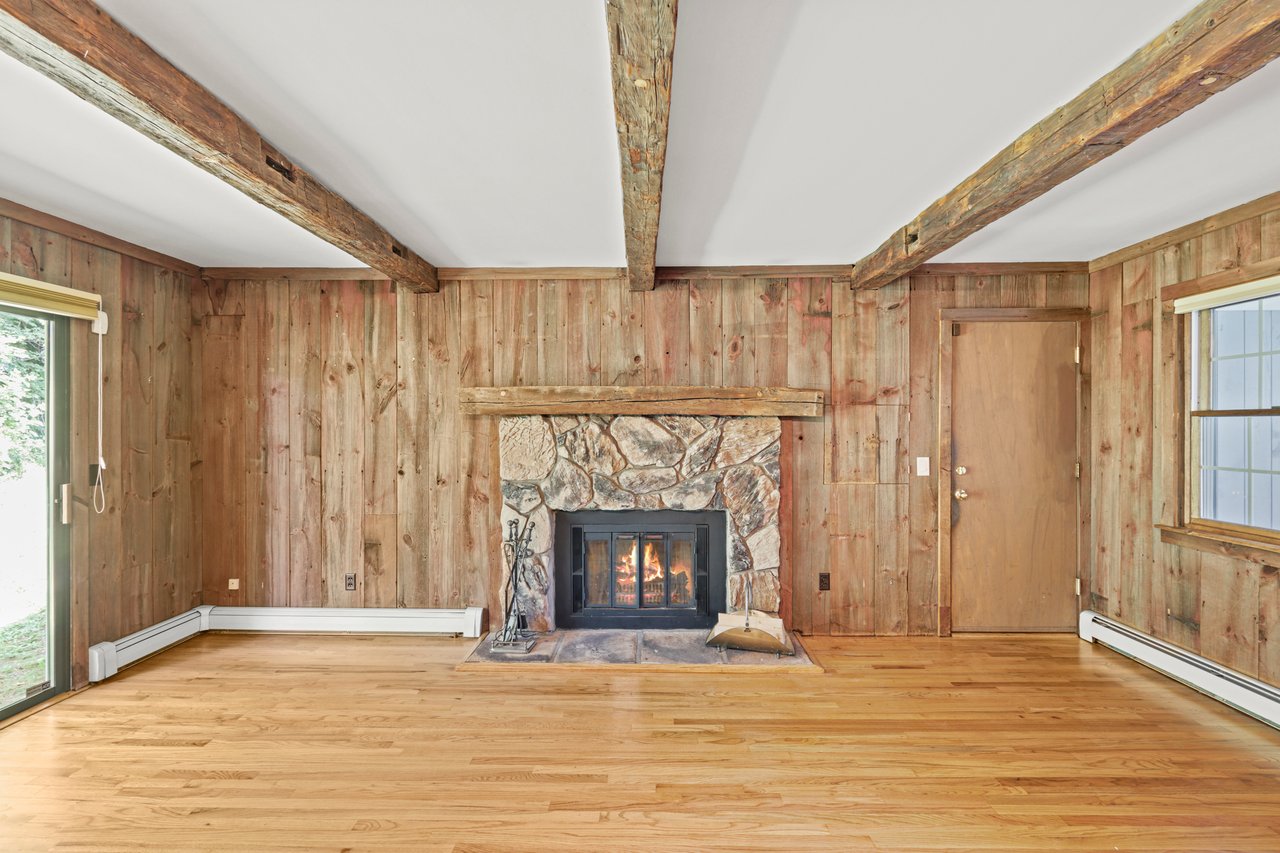 Beamed ceiling and stone fireplace