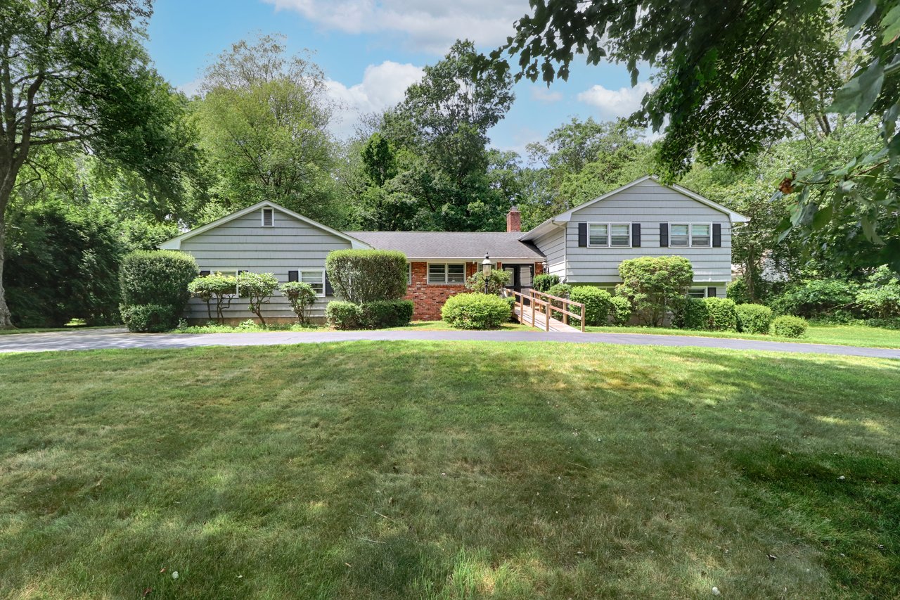 Welcome to 355 Surrey Lane with large semi-circular driveway providing abundant parking.