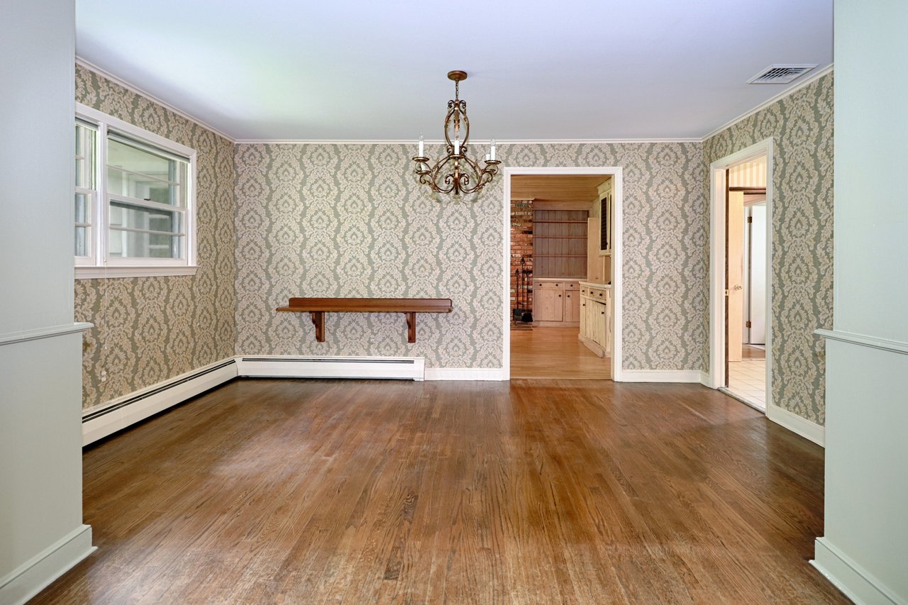 Dining room features built-in cabinets and hardwood floor.