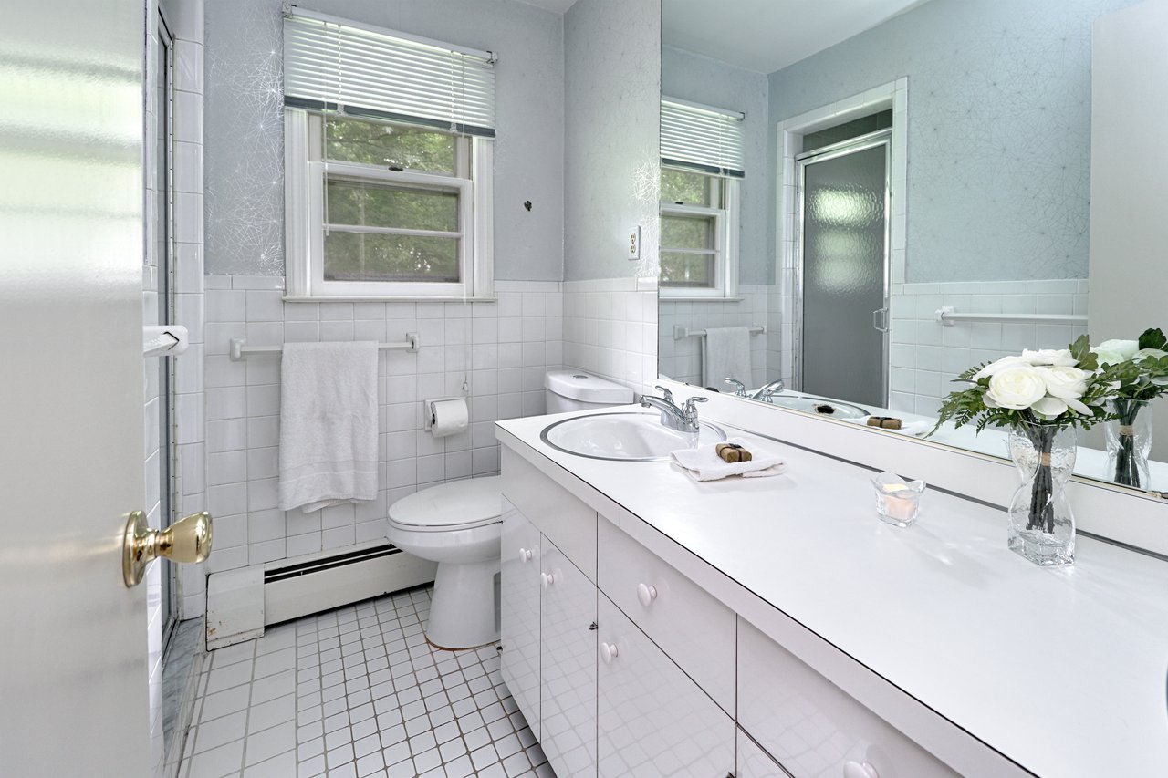 Full bath in primary suits features tile floor and shower.