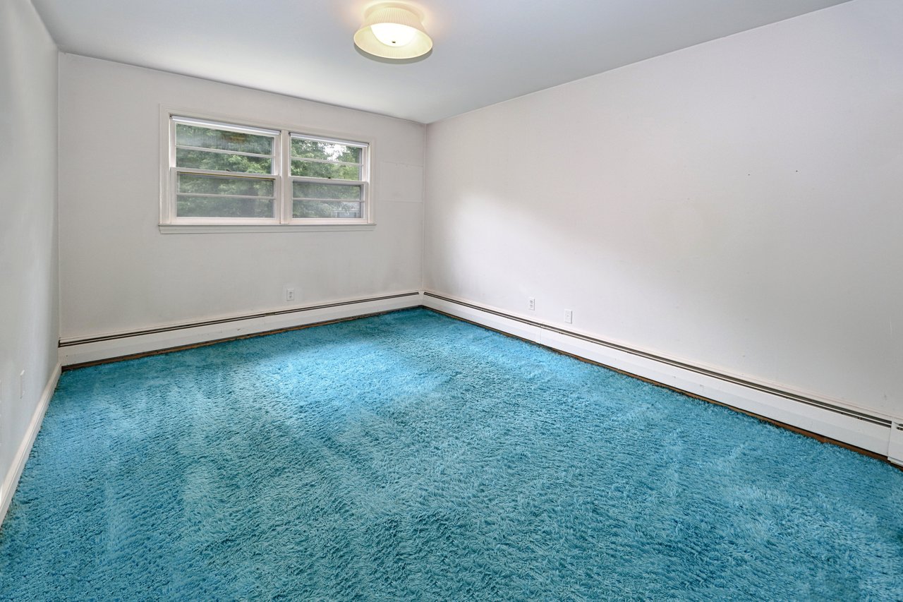 Bedroom #3 on upper level had hardwood floor and wall-to-wall carpet.