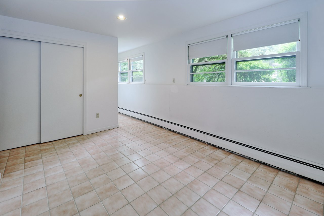 Alternate view of office/bedroom which features a cedar closet and 4 additional closets.