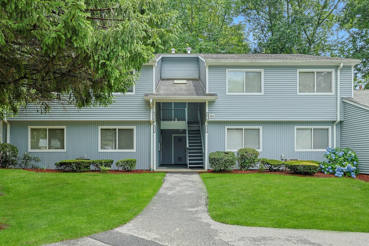 View of front facade with a front lawn, stairway