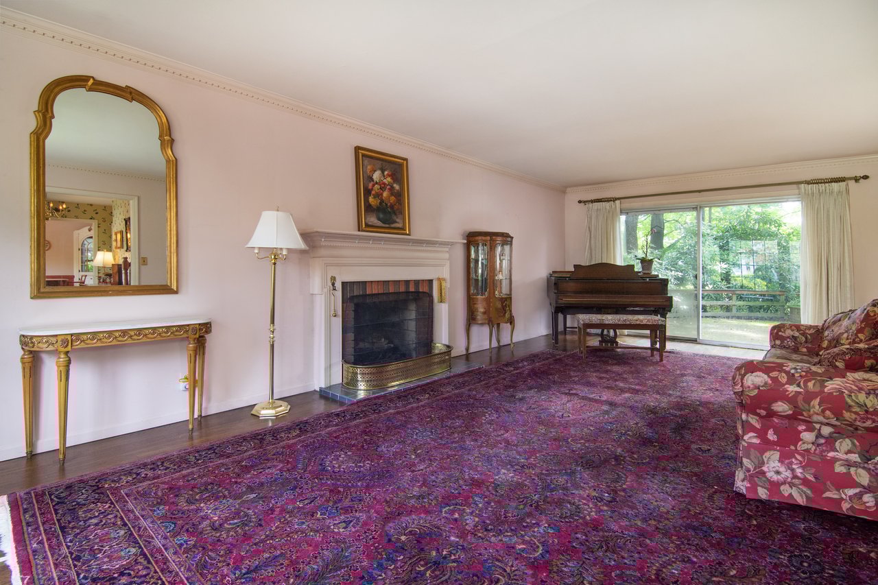 Delight in a gas fireplace fueled by city gas, original crown molding, and sliding doors that open seamlessly to the back patio and gardens.