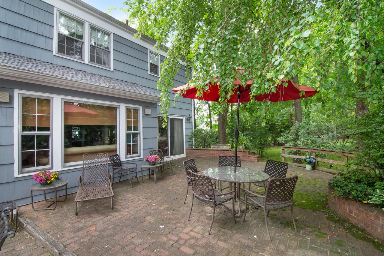 The backyard offers a magical outdoor setting with a charming bi-level patio finished in brick pavers.