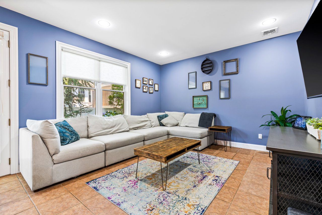 Spacious family room with high ceilings and recessed lighting