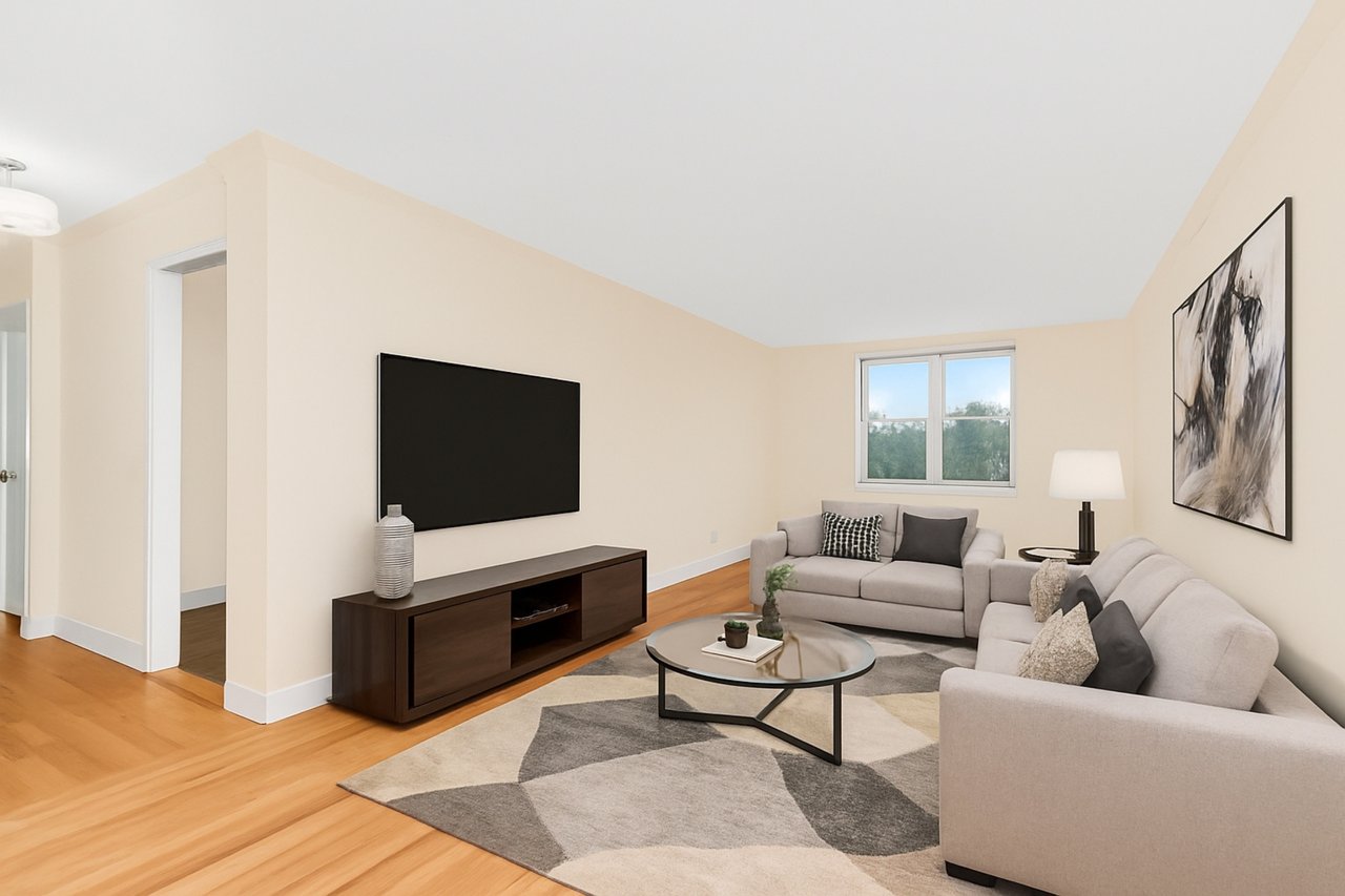 Living area featuring light wood-style floors, sunlit ** Virtually Staged**