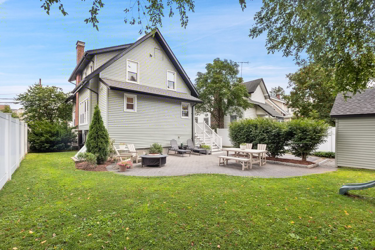 Back of house with a chimney, a patio, an outdoor fire pit, and a fenced backyard...
