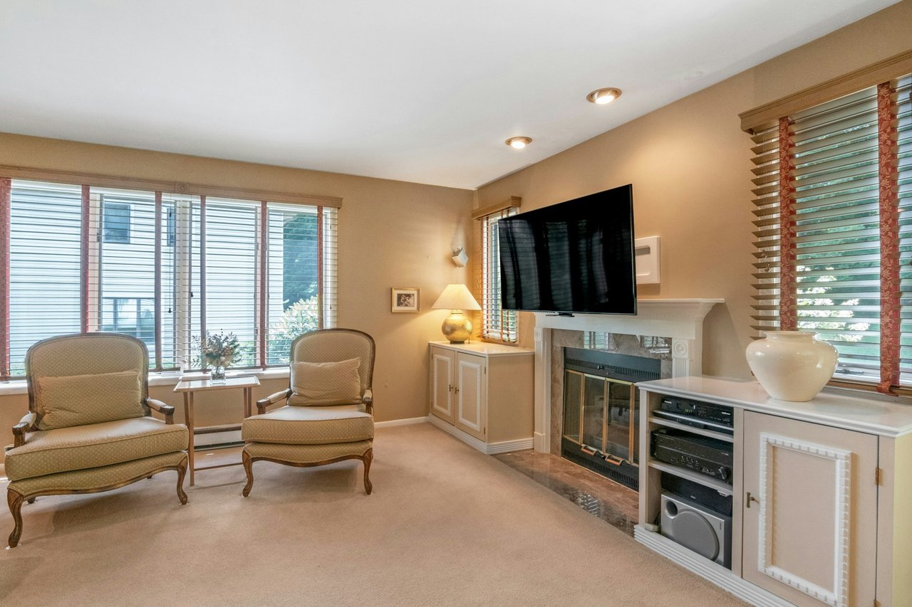 Living room featuring plenty of natural light, carpet floors, a fireplace, and recessed lighting