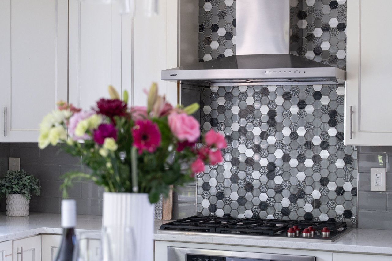 Bar featuring decorative backsplash and wall chimney exhaust hood