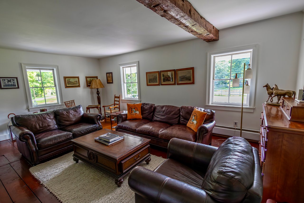 Living room with a baseboard radiator and wood-type flooring