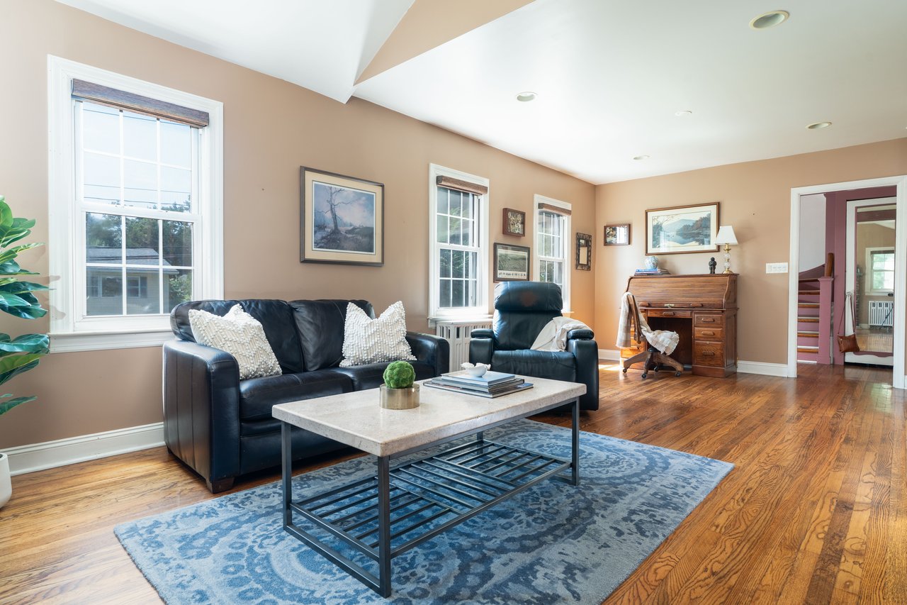 Living area with plenty of natural light, wood finished floors, and recessed lighting