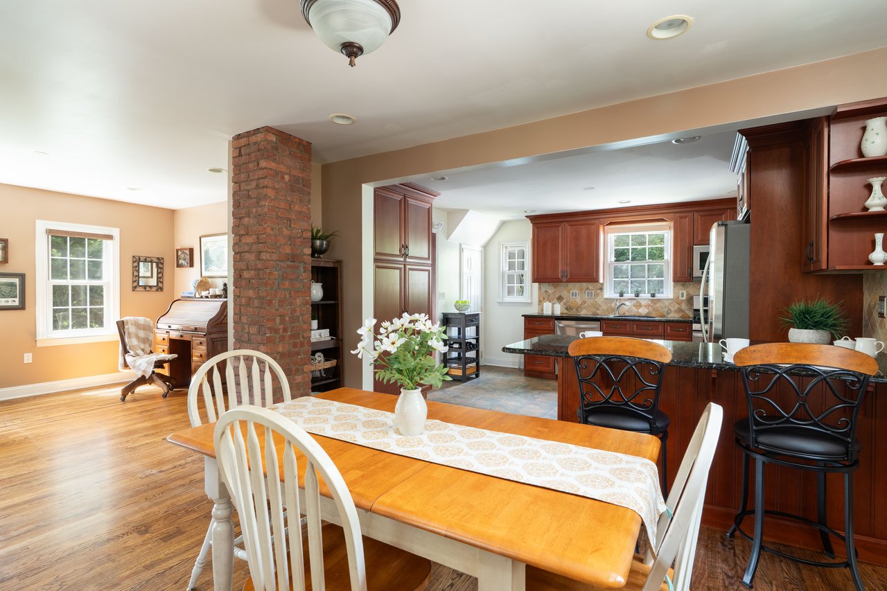 Dining room with ornate columns, light wood-type flooring, and recessed lighting