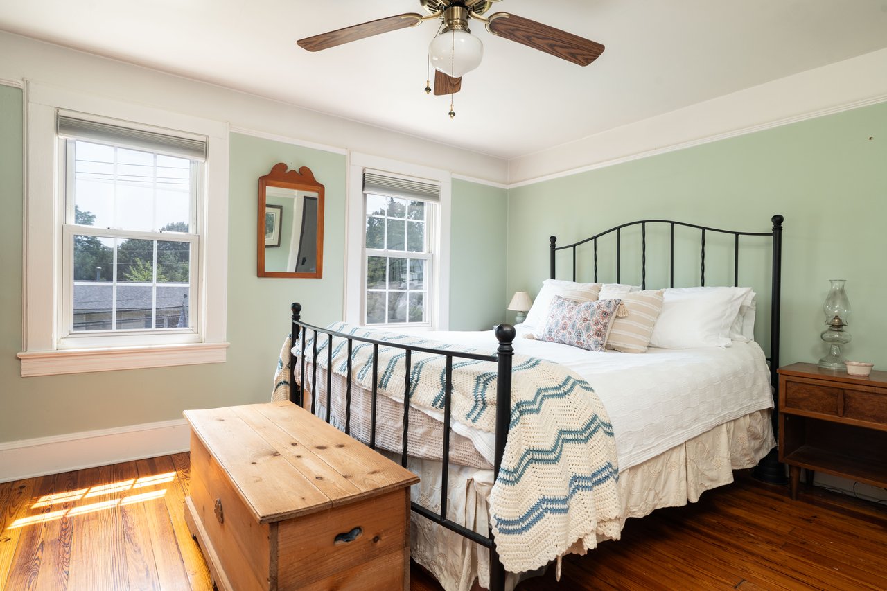 Bedroom featuring wood-type flooring and a ceiling fan