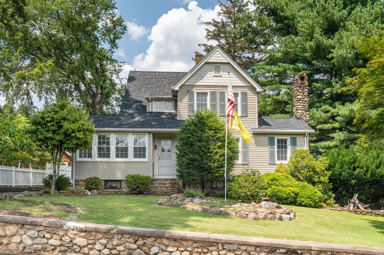 Victorian-style house with a chimney, entry steps, and a shingled roof