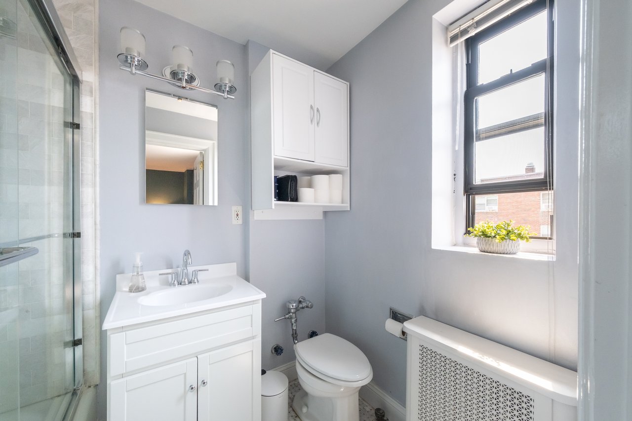 Bathroom featuring vanity and combined bath / shower with glass door