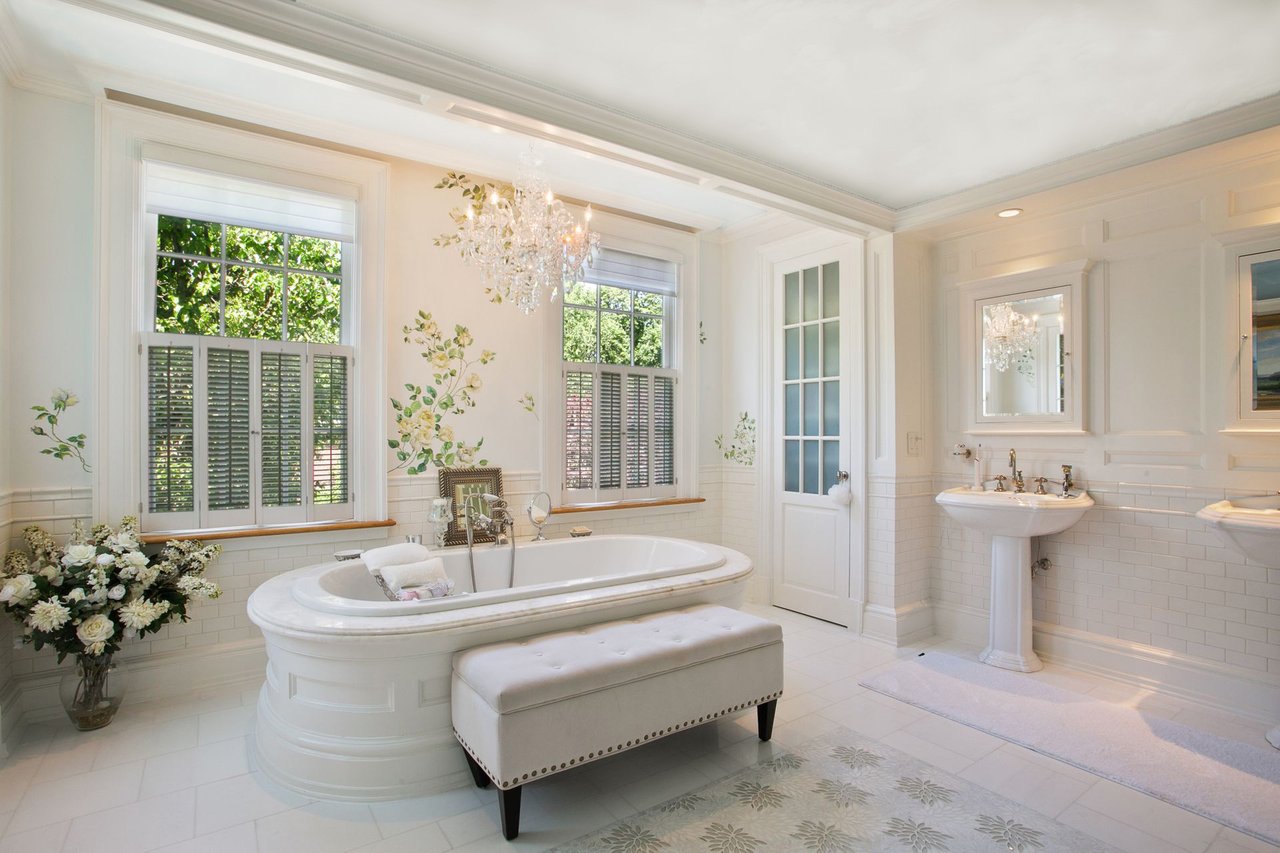 Impeccable Primary bath! Complete with marble stand-alone Jacuzzi tub with jets and double sinks. Custom floors with glass Mosaic tile and custom painted walls and ceiling make you feel like you are at the spa!