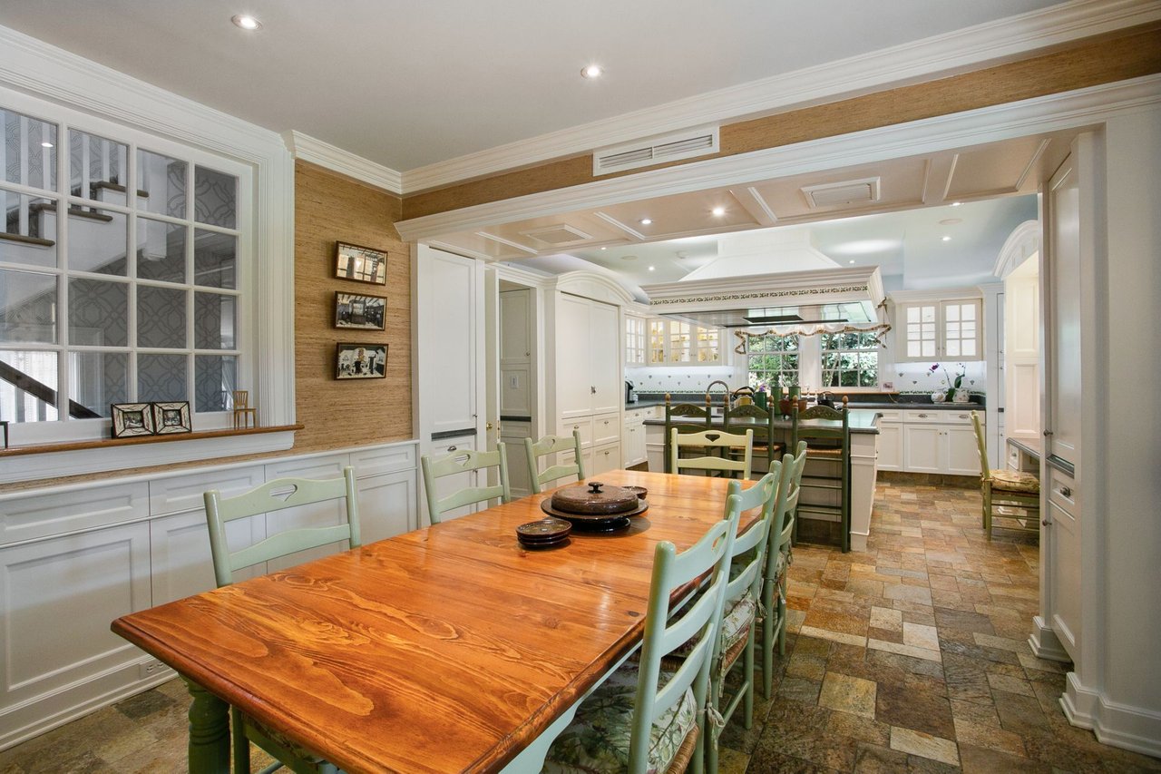 Charming eat-in area of the kitchen featuring second dishwasher, additional sink, and built-ins.