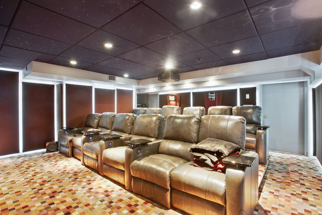 Enjoy your very own home theatre with concession area! 12 persons seating with built-in trays and cup holders for your convenience! Complete with surround sound, Da-Lite projection screen and Digital monitor.