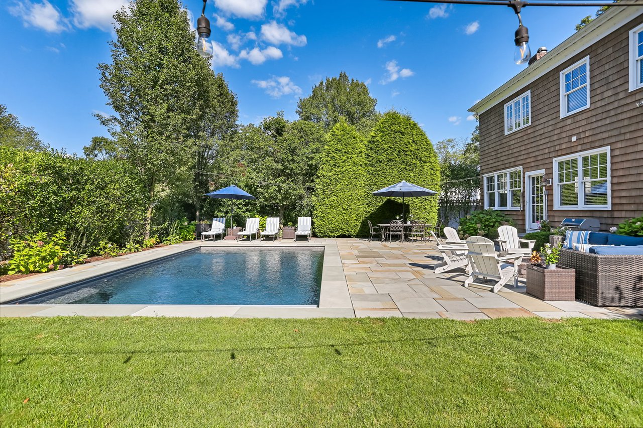 View of backyard with gunite pool and saftey cover