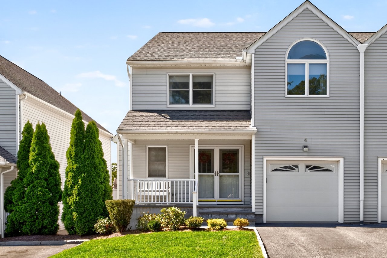 Townhouse lifestyle with a single home feel. Covered porch, driveway, and a garage.